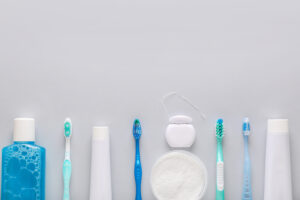 白い背景に並ぶ歯ブラシやフロスなど、デンタルツール